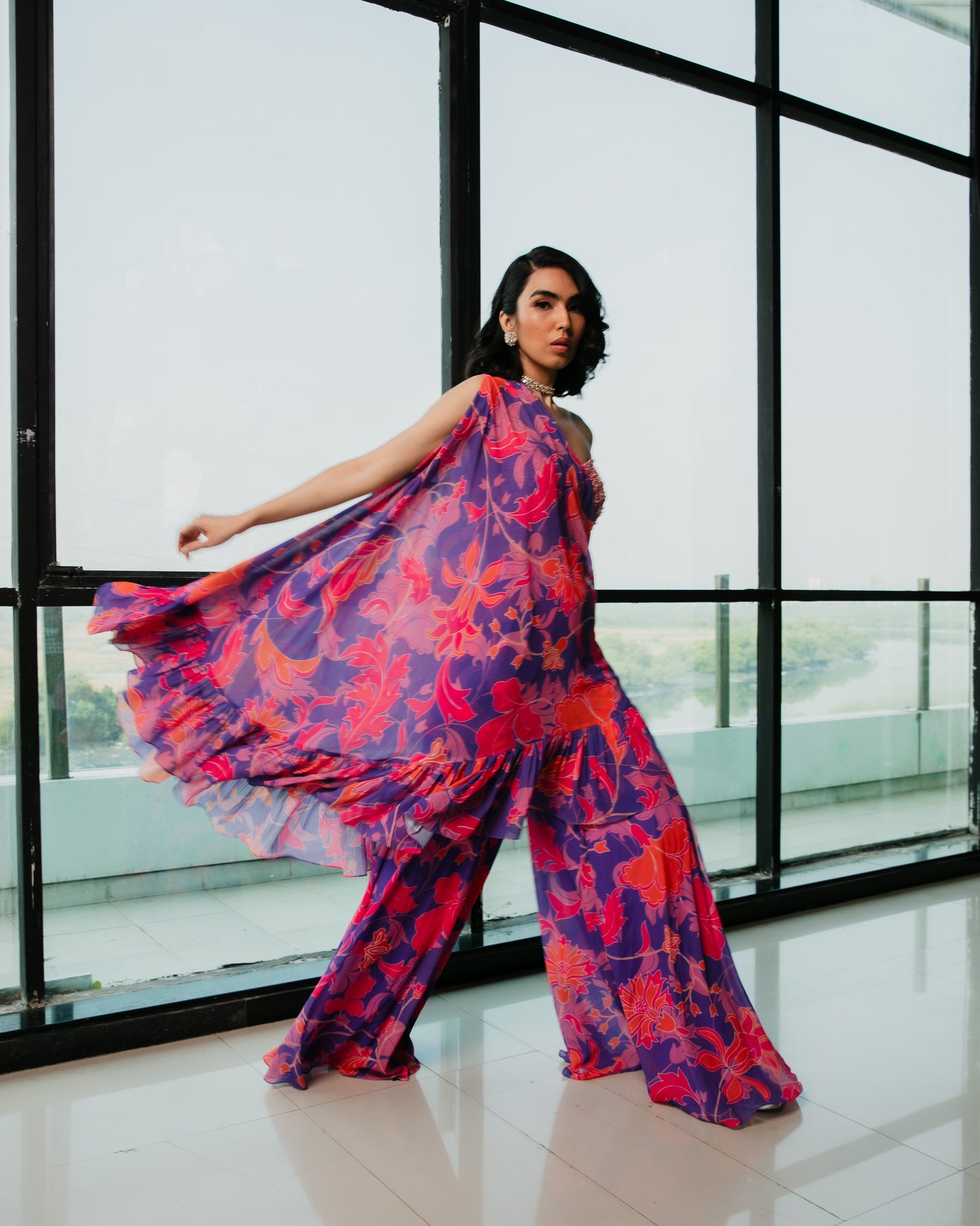 Signature one side ruffle cape with an embroidered bustier and sharara pants